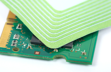 Close-up view of a micro radio frequency identification label antenna and chip, showcasing precision aluminum etched circuit design.