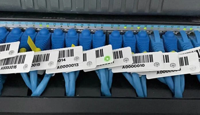 LED RFID Label A close-up of blue network cables labeled with LED RFID cable tags featuring barcodes and tracking numbers