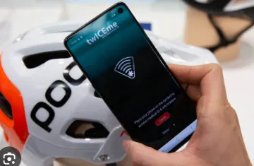 NFC Health Rescue A person using a smartphone to read an NFC health rescue tag embedded in a sports helmet for emergency medical data access