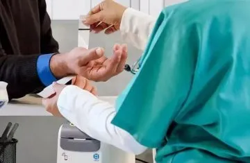 tracking wristbands A healthcare professional interacting with an NFC-enabled medical wristband and emergency data scanner for patient health tracking