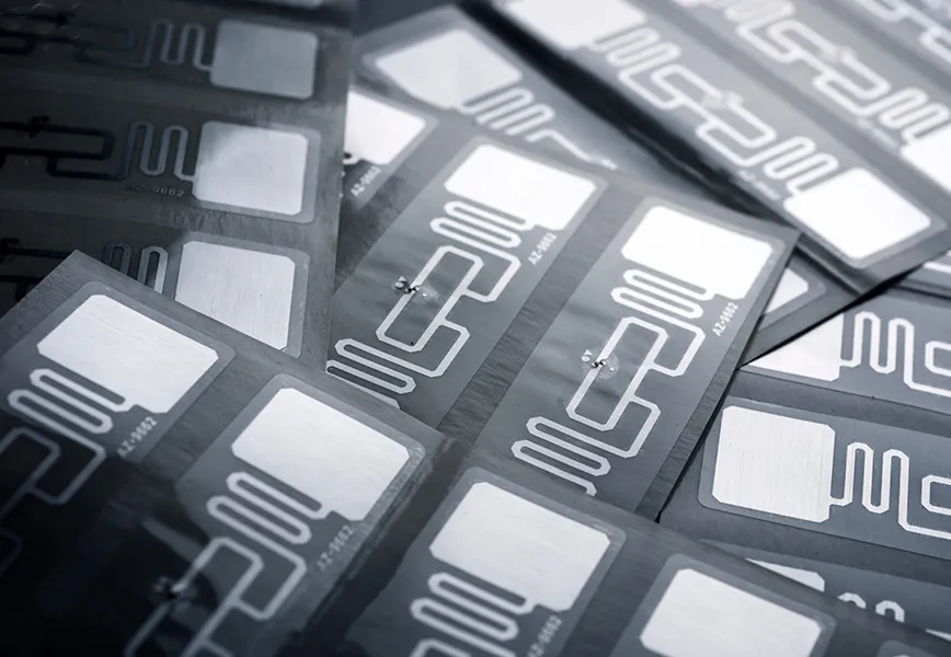 Why select Tamper-Evident Close-up of Stacked Printed RFID Antenna Inlays on Dark Sheets
