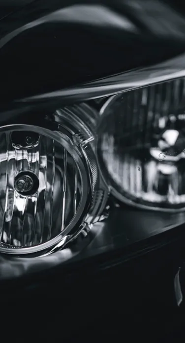 vehicle Close-up of a Car Headlight Assembly in Monotone
