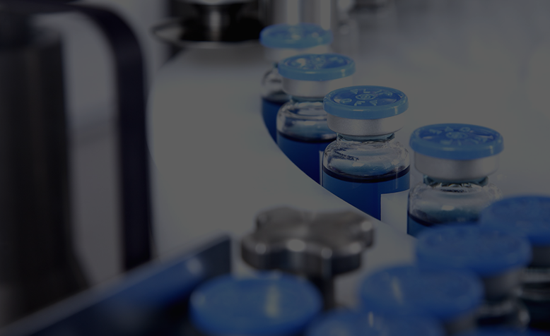 Healthcare & Pharmaceuticals Pharmaceutical Vials with Blue Caps on a Production Line Conveyor