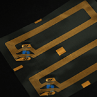 Close-up of Golden RFID Inlays with Copper Antenna Traces
