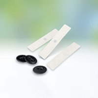 White RFID Tags and Black Garment Buttons on a Light Background