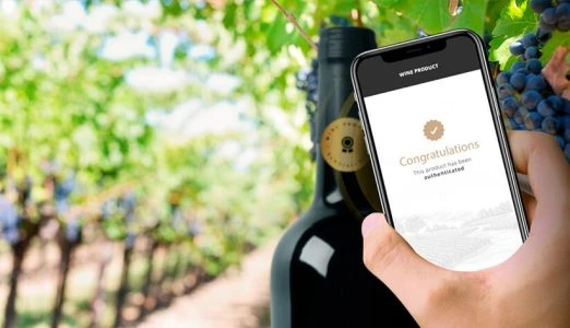 NFC Label Smartphone Displaying Product Authentication in a Vineyard Setting