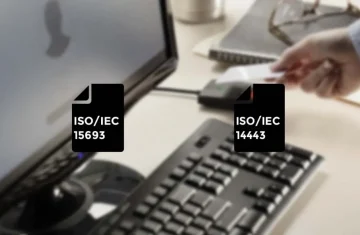 HF Short Range RFID Reader ISO 15693 or 14443 A person scanning an RFID card near a reader with ISO/IEC 14443 and 15693 standards displayed.