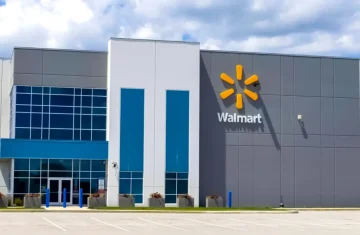 Walmart RFID Requirements What If Your RFID Tags Do Not Meet Requirements A Walmart store exterior with a large logo on a modern building under a cloudy sky.