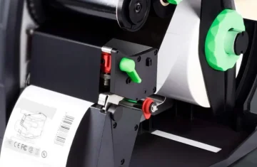 Close up of a barcode printer printing a label.