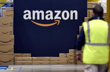 Amazon Warehouse Operations Amazon warehouse with stacks of boxes and employees working.