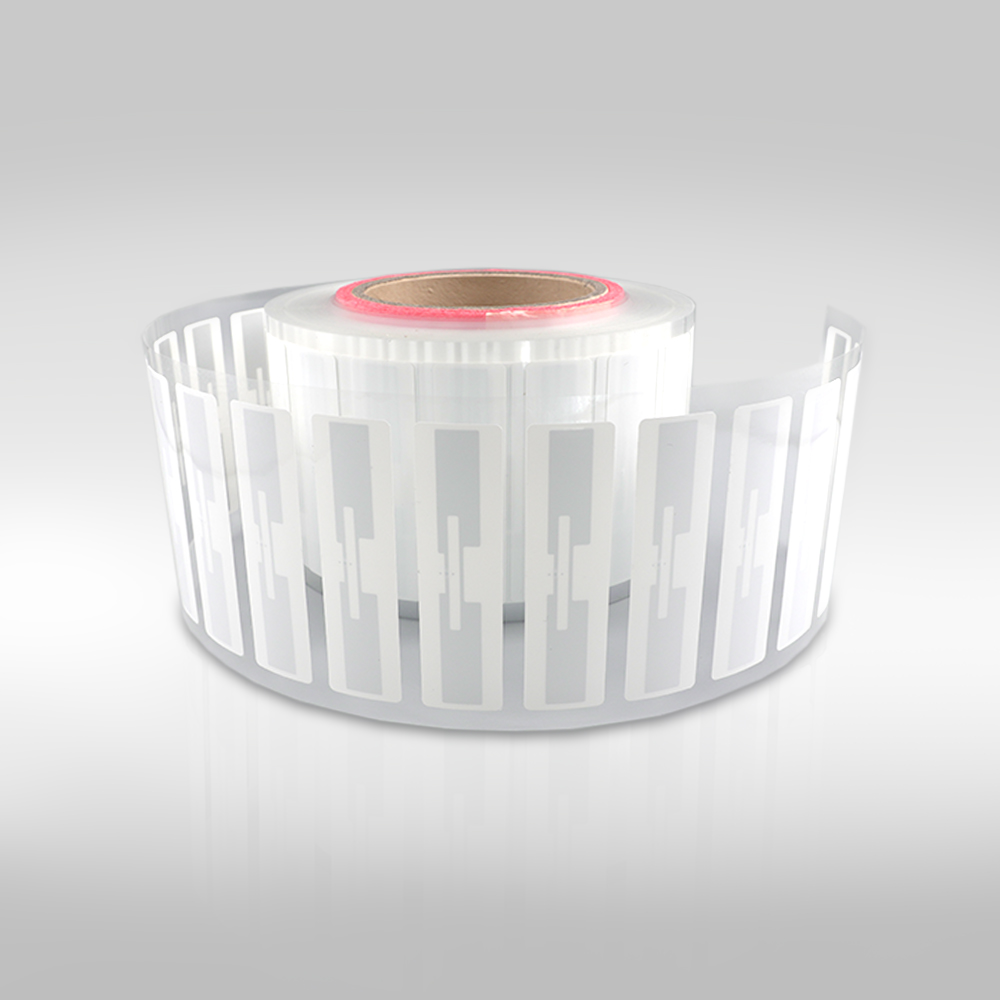 A roll of RFID label paper with clear rectangular tags.