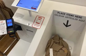 Uniqlo self-checkout system where items are placed for scanning.