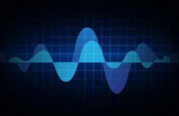Digital wave graph on dark grid background. Digital wave graph in blue and black on a dark grid.