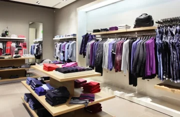 Modern Clothing Store Interior The interior of a modern, upscale clothing store with neatly organized racks and shelves of men's and women's apparel.