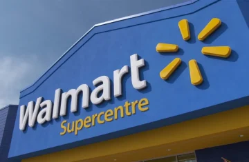 Walmart Supercentre Storefront The exterior sign of a Walmart Supercentre store, showing the logo against a blue sky.