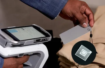 Scanning RFID Tag on Clothing in Retail Store Retail worker scanning an RFID tag on clothing in a store.