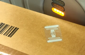 Logistics Package RFID Tracking Brown package with RFID tag and barcode being scanned by a device with orange lights
