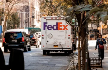 FedEx delivery truck on a city street, representing RFID enabled logistics and shipment visibility.